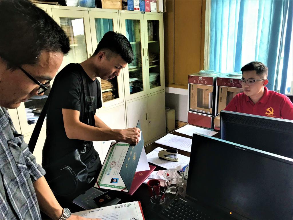 (图为学生党员为研究生新生报到注册)